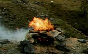 A fire on rocks on a hill

AI-generated content may be incorrect.