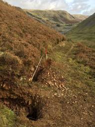 A hill with a hole in the ground

AI-generated content may be incorrect.
